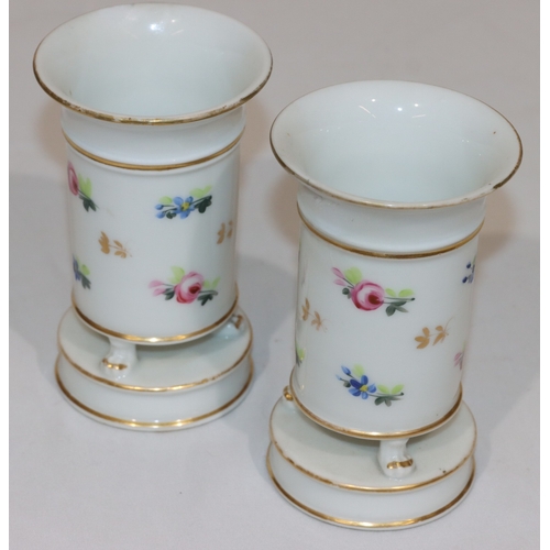 75 - A pair of 19th Century round trumpet shaped vases on white ground with hand painted floral, leaf and... 