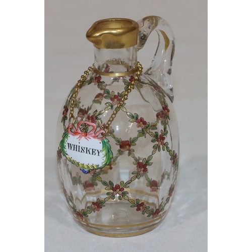 77 - A Continental small round bulbous thin necked whisky jug with raised multi-coloured floral, leaf and... 