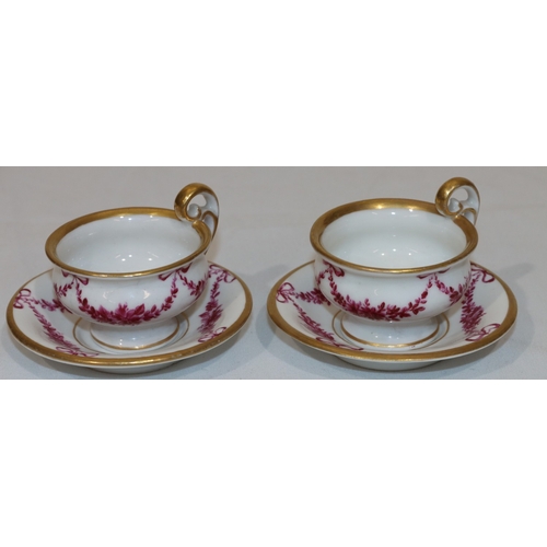 82 - A pair of 18th/19th Century Copenhagen small cups and saucers on white ground with puce floral, swag... 