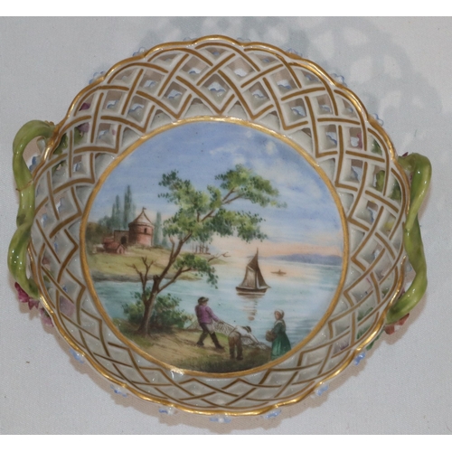 83 - A Continental small porcelain round 2-handled basket with centre scene depicting fisherman pulling i... 