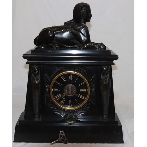 898 - A heavy black slate 8-day striking mantel clock with marble Egyptian sphinx to top, black dial surro... 