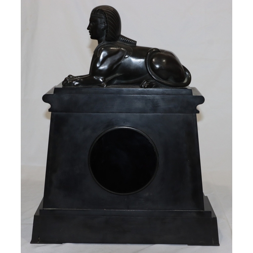 898 - A heavy black slate 8-day striking mantel clock with marble Egyptian sphinx to top, black dial surro... 