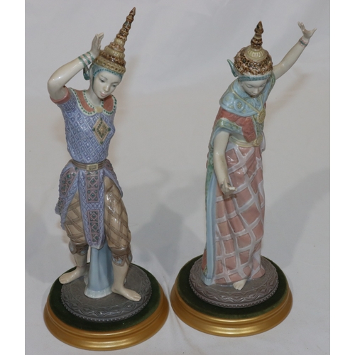 92 - A pair of Lladro figures of Eastern dancers on round gilt bases (lady dancer has 3 fingers missing f... 