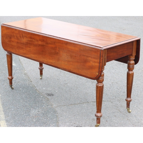 924 - A large 19th Century mahogany Pembroke table with 1 end drawer on round turned legs and brass castor... 