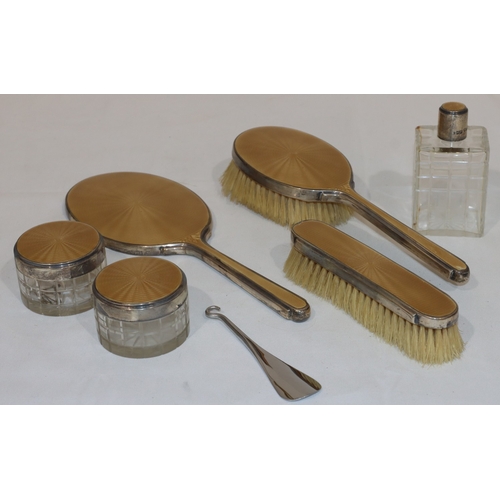 181 - A Mappin & Webb silver and champagne coloured enamelled dressing table set, comprising of hand mirro... 