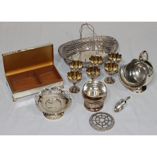 194 - An oval silver plated egg stand with fixed overhead handle mounted with 6 removable egg cups, pierce... 