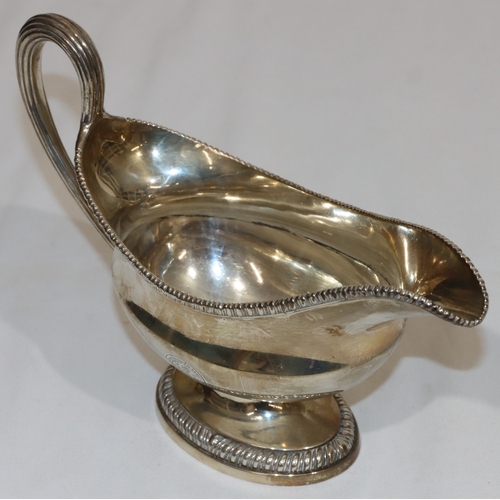 203 - An early George III silver oval sauce boat with gadroon rim, reeded handle, on oval splayed base, en... 