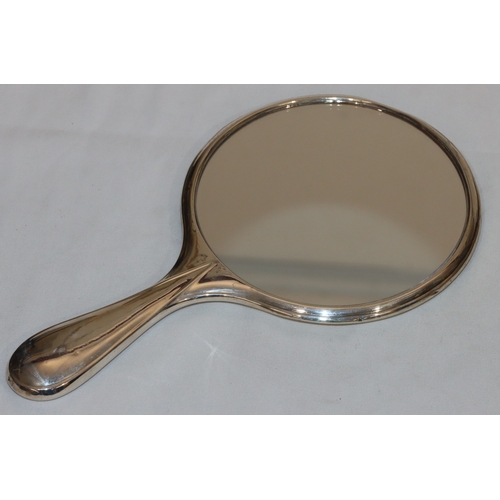 210 - A Birmingham silver part hammered dressing table hand mirror