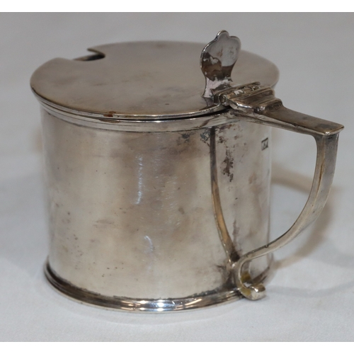 212 - An Edward VII silver round mustard pot with hinged lid enclosing blue glass liner, London 1903, make... 