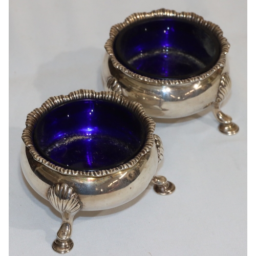 213 - A pair of early George III silver round bulbous shaped salts with crinkle rims with blue glass liner... 