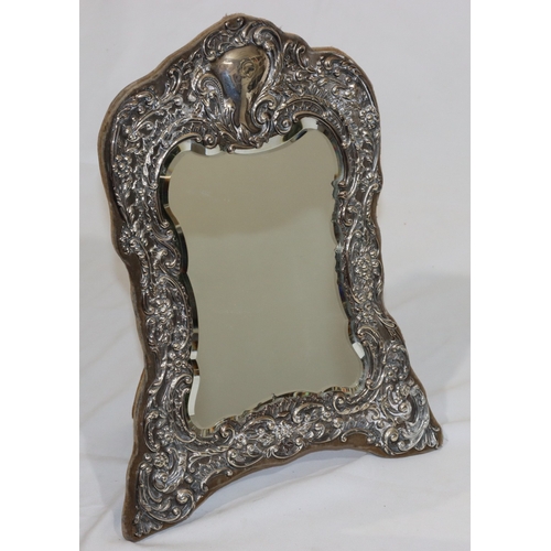 215 - A late Victorian silver mounted freestanding bevelled dressing table mirror with embossed floral, le... 