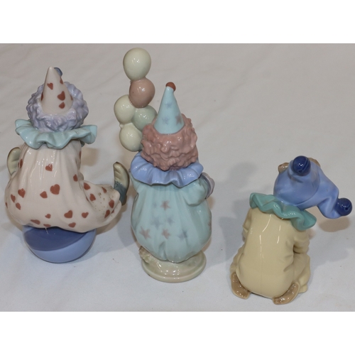 22 - 2 Lladro figurines of clowns, 18cm high and a similar Nao figure (3)