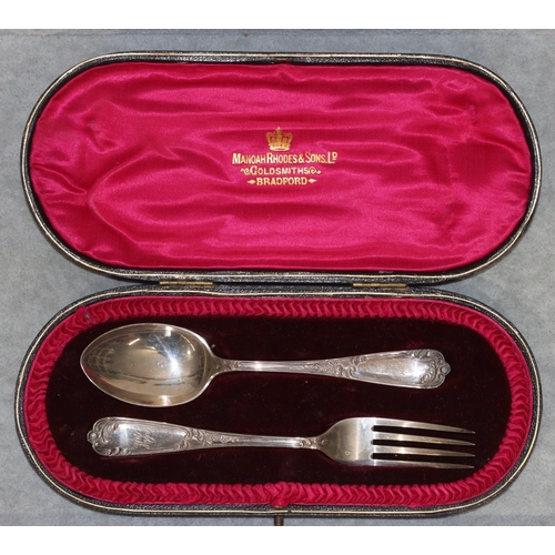 266 - A pair of Sheffield silver child's fork and spoon with raised leaf and scroll decoration, in fitted ... 