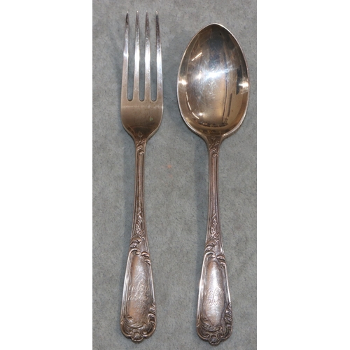 266 - A pair of Sheffield silver child's fork and spoon with raised leaf and scroll decoration, in fitted ... 