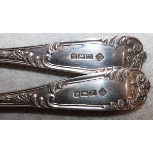 266 - A pair of Sheffield silver child's fork and spoon with raised leaf and scroll decoration, in fitted ... 