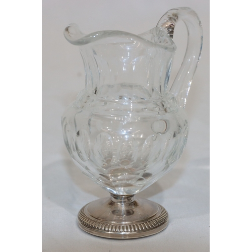 270 - A 19th Century cut glass small round bulbous shaped cream jug with thumb pattern decoration on round... 