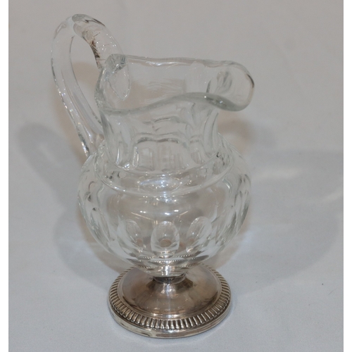 270 - A 19th Century cut glass small round bulbous shaped cream jug with thumb pattern decoration on round... 