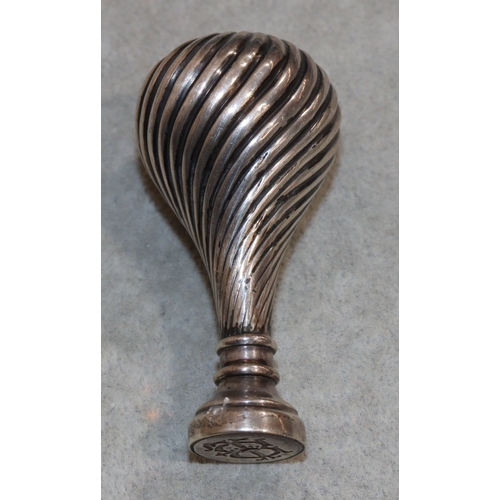 272 - A heavy silver coloured metal round bulbous shaped desk seal with embossed reeded decoration and eng... 