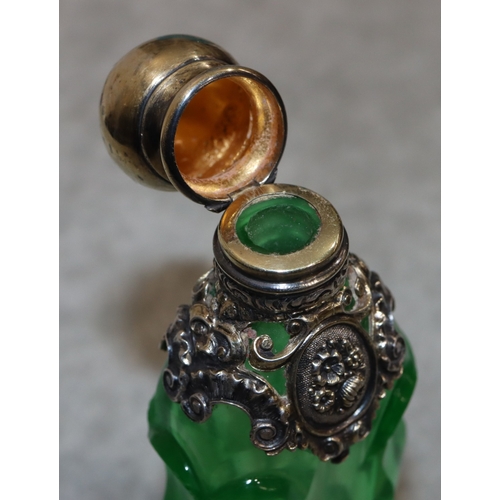 276 - A 19th Century cut glass rectangular shaped scent bottle with thumb pattern decoration and silver an... 