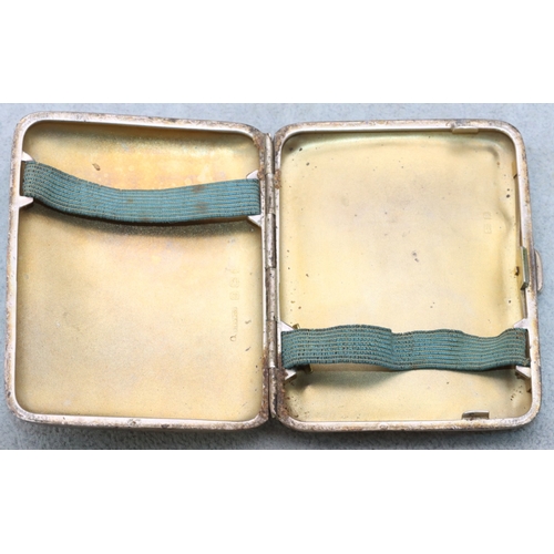 286 - A concave shaped cigarette case with allover chased floral and scroll decoration and hinged front, B... 