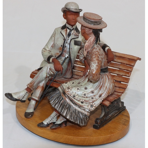 30 - Bill Dowsett, painted earthenware group of lady and gentleman seated on park bench, mounted on oval ... 