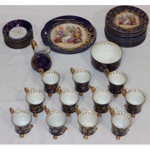 36 - An Austrian tea service on royal blue ground with coloured panels of figures and allover gilt decora... 