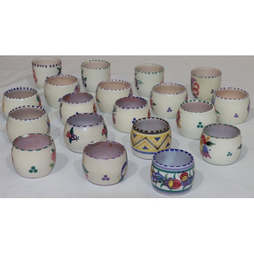 41 - A set of 4 Poole Pottery round bulbous shaped egg cups with multi-coloured floral and leaf decoratio... 