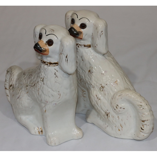 6 - A pair of 19th Century Staffordshire figures of seated spaniels on white ground with gilt painted de... 