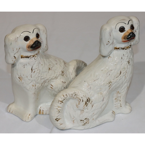 6 - A pair of 19th Century Staffordshire figures of seated spaniels on white ground with gilt painted de... 