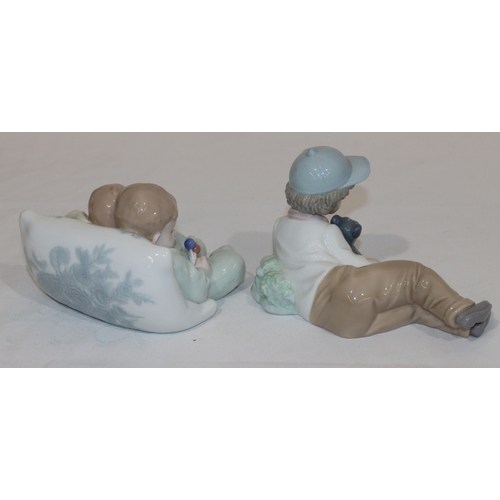 64 - A Lladro group of 2 sleeping babies, 14.5cm wide and a Nao figure of a young boy resting holding a d... 