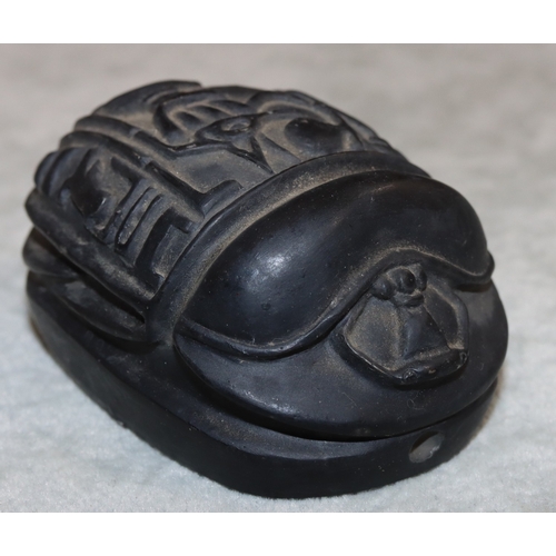 701 - A black hardstone scarab, 7.2cm long