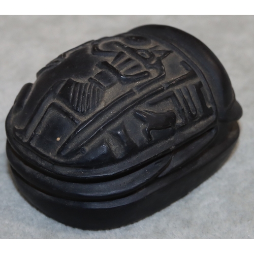 701 - A black hardstone scarab, 7.2cm long