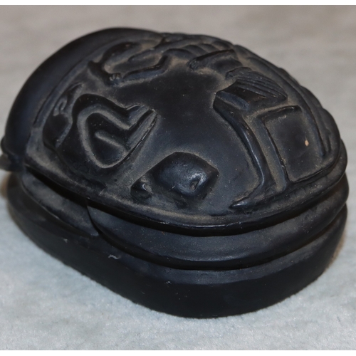 701 - A black hardstone scarab, 7.2cm long