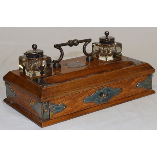 703 - A Victorian oak rectangular shaped inkstand with silver plated centre handle and various silver plat... 