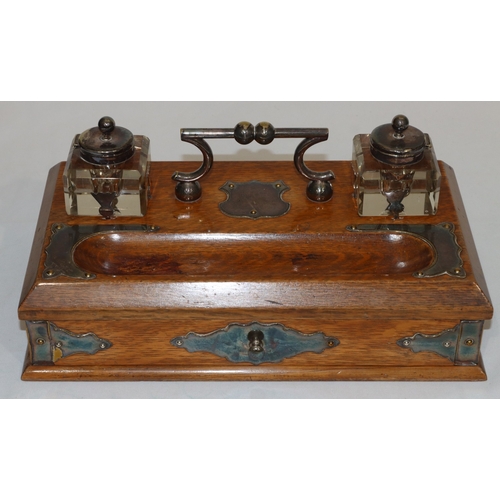 703 - A Victorian oak rectangular shaped inkstand with silver plated centre handle and various silver plat... 