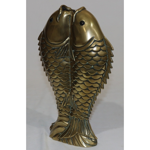 704 - An Oriental heavy brass vase in the form of 2 fish, 28cm high