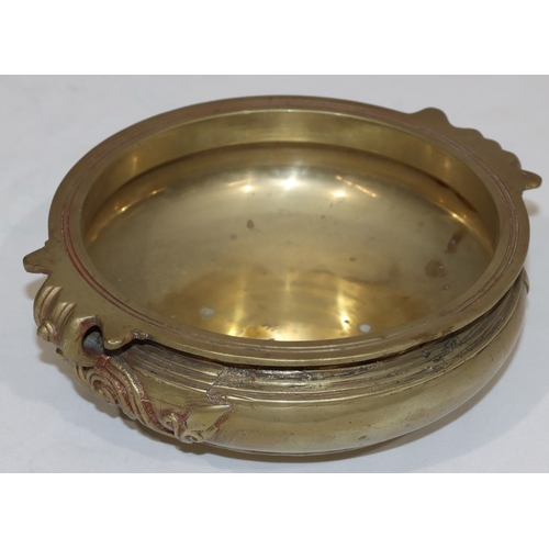 708 - An Oriental gilt bronze round bulbous bowl with raised scroll decoration, 23cm wide