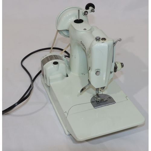 725 - A Singer Featherweight sewing machine, Model 221, on white ground, in pale blue case