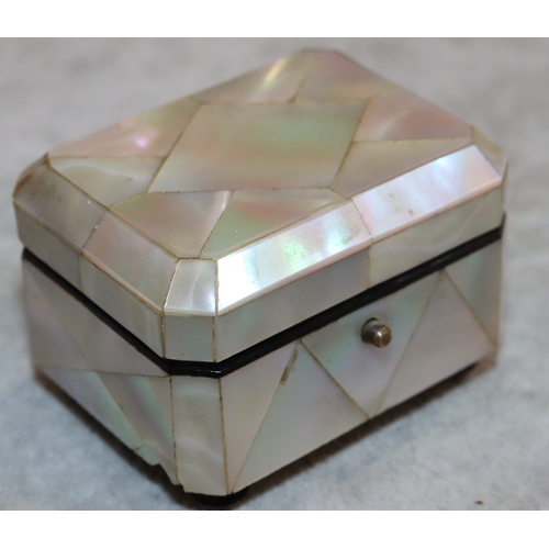 733 - A miniature Mother of Pearl musical box in the form of a casket with hinged lid, winder stamped REUG... 