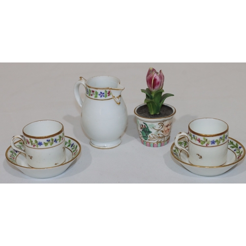 74 - A pair of Continental coffee cups and saucers on white ground with multi-coloured hand painted flora... 