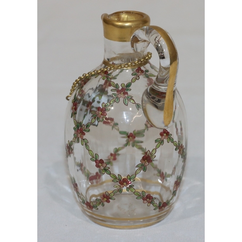 77 - A Continental small round bulbous thin necked whisky jug with raised multi-coloured floral, leaf and... 