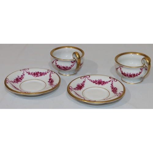 82 - A pair of 18th/19th Century Copenhagen small cups and saucers on white ground with puce floral, swag... 