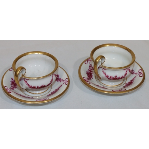 82 - A pair of 18th/19th Century Copenhagen small cups and saucers on white ground with puce floral, swag... 