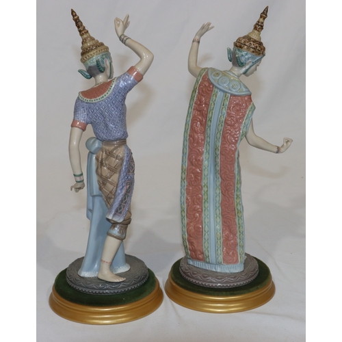 92 - A pair of Lladro figures of Eastern dancers on round gilt bases (lady dancer has 3 fingers missing f... 