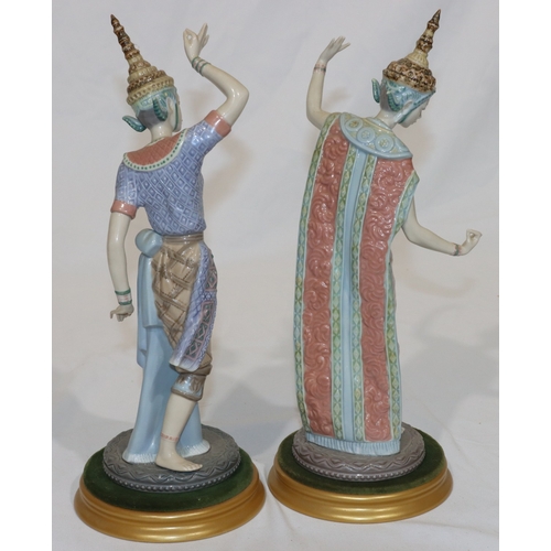 92 - A pair of Lladro figures of Eastern dancers on round gilt bases (lady dancer has 3 fingers missing f... 