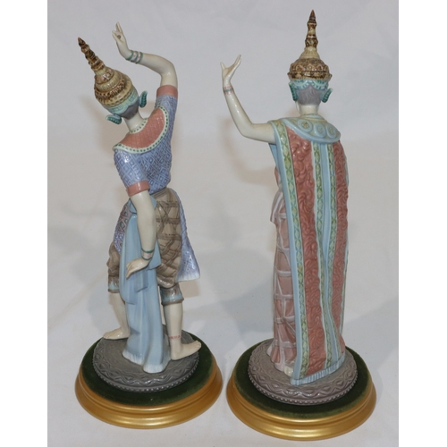 92 - A pair of Lladro figures of Eastern dancers on round gilt bases (lady dancer has 3 fingers missing f... 