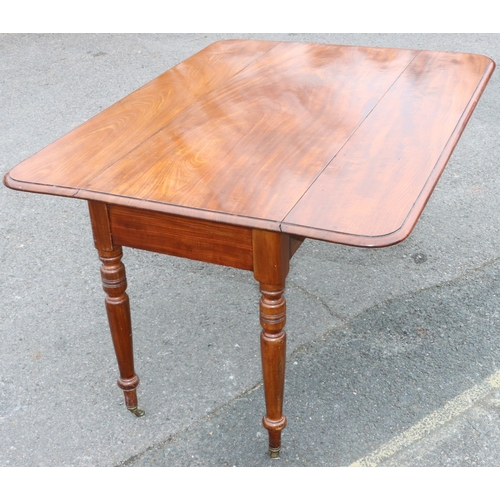 924 - A large 19th Century mahogany Pembroke table with 1 end drawer on round turned legs and brass castor... 