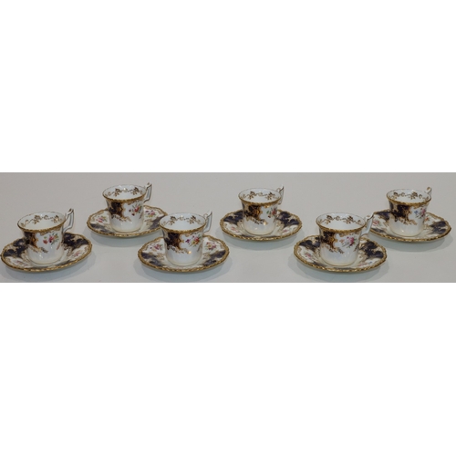 124 - A set of 6 Coalport cups and saucers on white and blue ground with multi-coloured floral, leaf and g... 