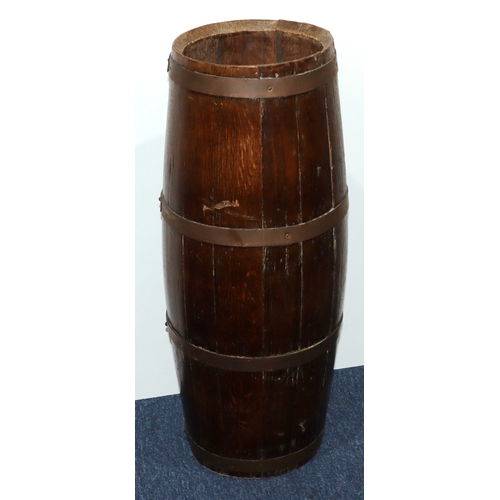 931 - An oak circular bulbous shaped umbrella stand in the form of a barrel with brass banding, 68cm high