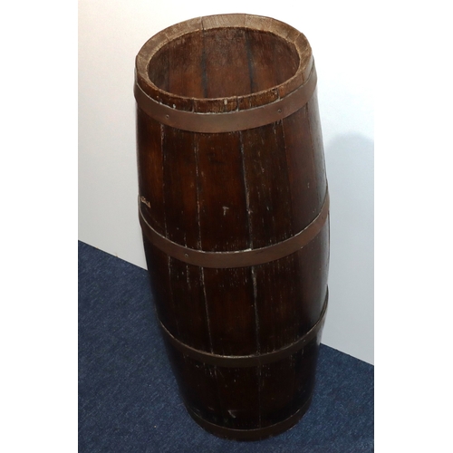 931 - An oak circular bulbous shaped umbrella stand in the form of a barrel with brass banding, 68cm high